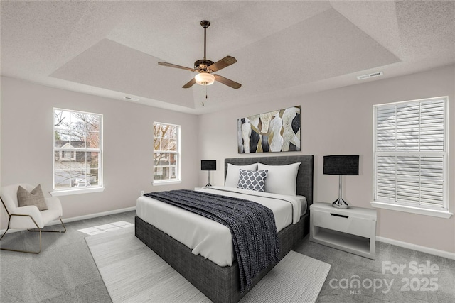 9138 Babbitt Way, Charlotte, NC 28216 - bedroom with carpet floors, a tray ceiling, ceiling fan, and a textured ceiling