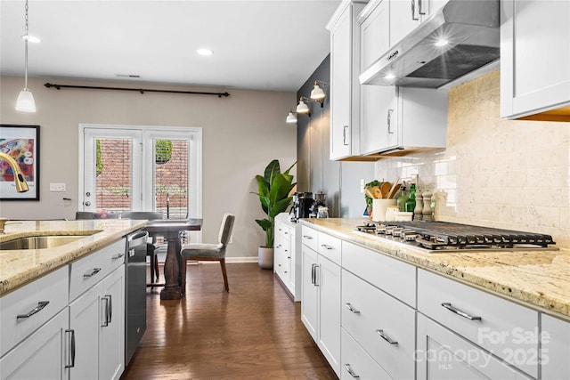 kitchen featuring under cabinet range hood, white cabinets, appliances with stainless steel finishes, and tasteful backsplash