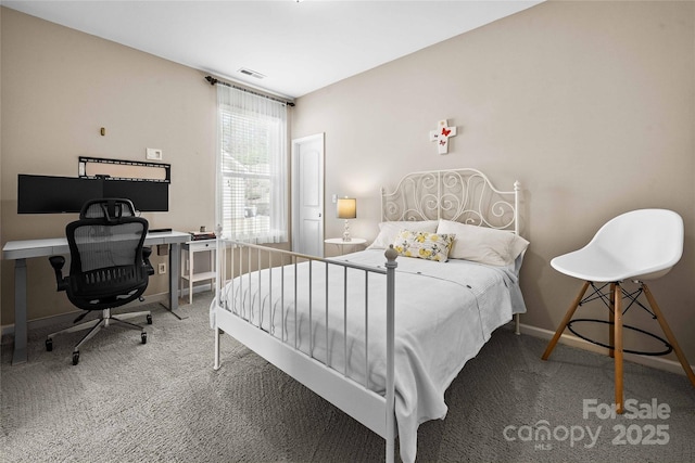 carpeted bedroom with visible vents and baseboards