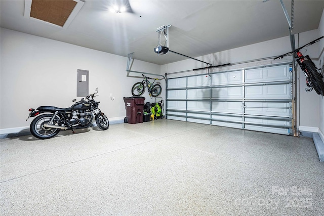 garage featuring electric panel, baseboards, and a garage door opener