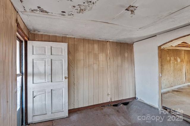 spare room with wooden walls