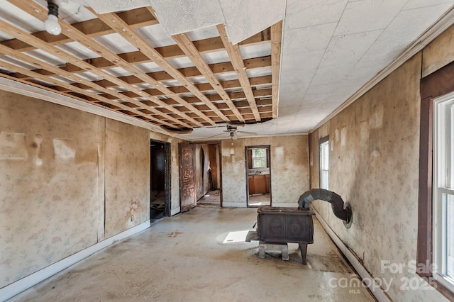 interior space with concrete floors and a ceiling fan