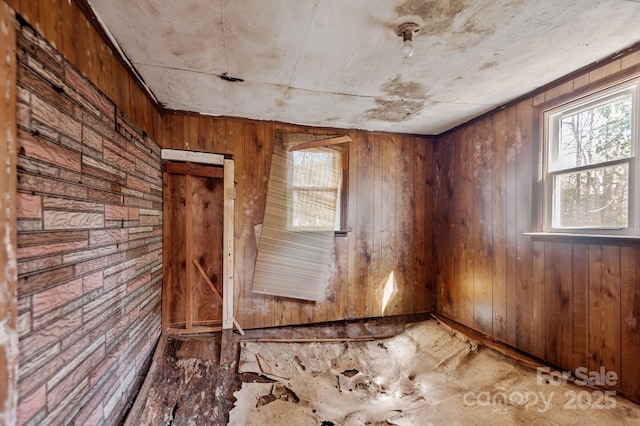 spare room with wood walls