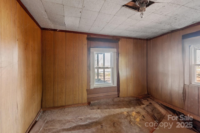 spare room featuring wooden walls