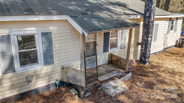 view of property exterior featuring roof with shingles