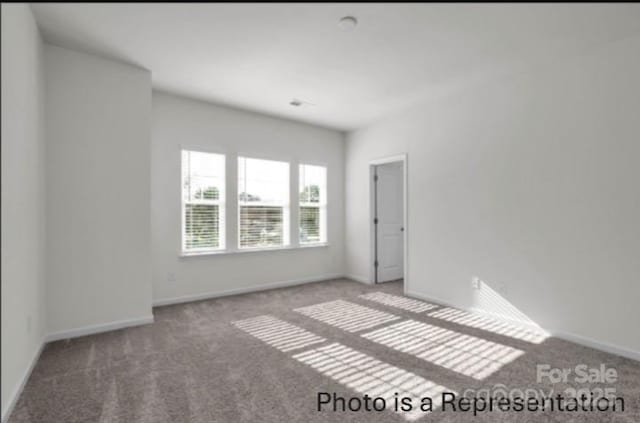 spare room with carpet flooring and baseboards