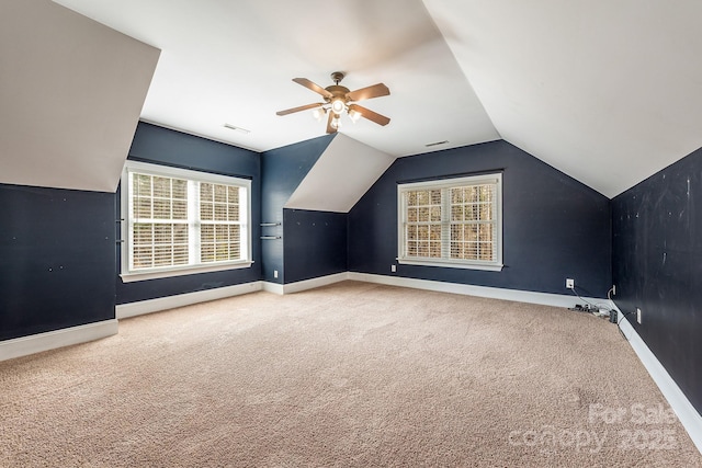 additional living space featuring lofted ceiling, carpet flooring, visible vents, and baseboards