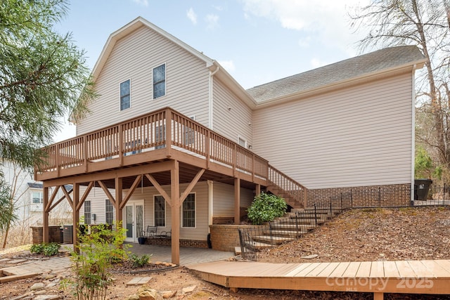 back of house featuring french doors, stairway, a patio area, and a wooden deck