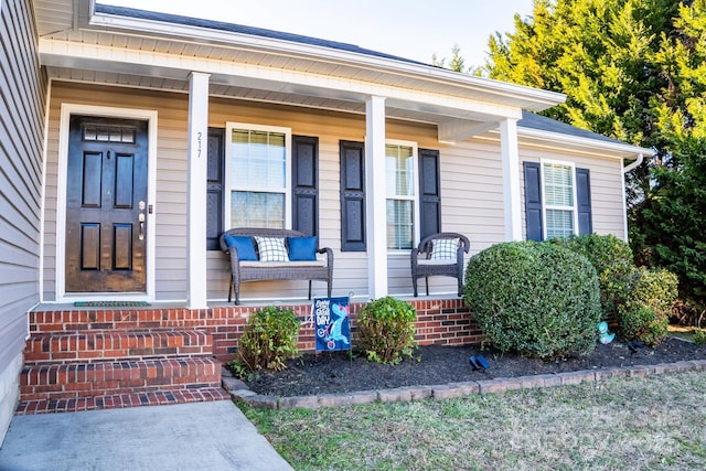 view of exterior entry with a porch