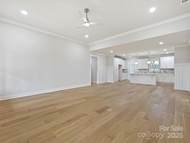 unfurnished living room with crown molding, ceiling fan, recessed lighting, and light wood-style floors