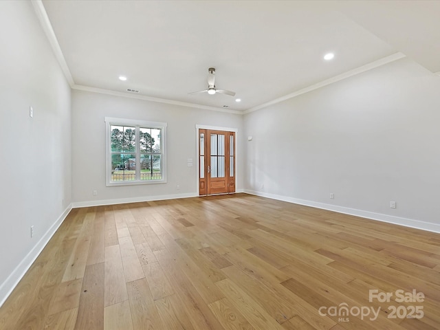 empty room featuring visible vents, baseboards, light wood-style flooring, ornamental molding, and recessed lighting