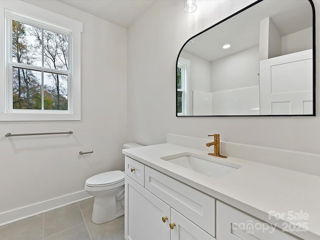 bathroom with recessed lighting, toilet, vanity, baseboards, and tile patterned floors