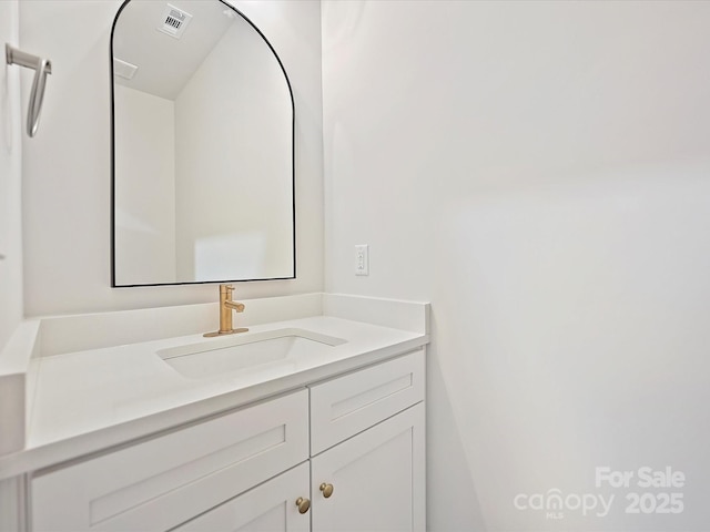 bathroom with vanity and visible vents