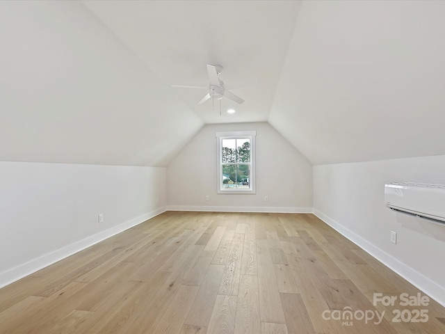 additional living space featuring light wood-type flooring, vaulted ceiling, baseboards, and ceiling fan