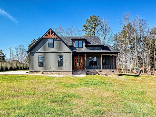 modern farmhouse style home with roof with shingles, crawl space, a front yard, and board and batten siding