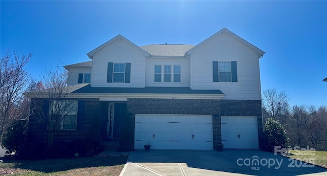 traditional-style home with an attached garage, driveway, and brick siding