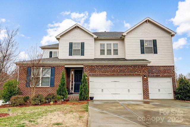 traditional-style house with a garage, brick siding, driveway, and a shingled roof