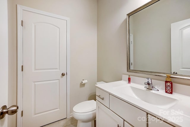 bathroom featuring tile patterned floors, toilet, and vanity