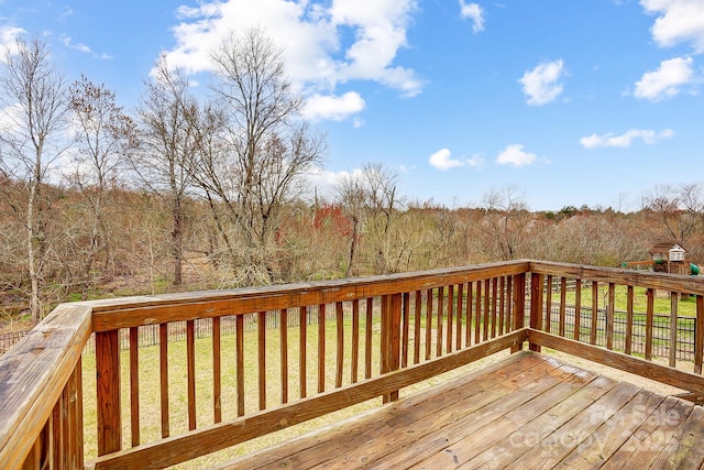 deck with a yard and a forest view