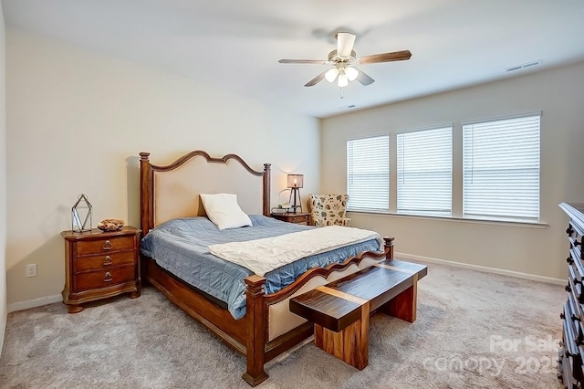 carpeted bedroom with a ceiling fan, baseboards, and visible vents