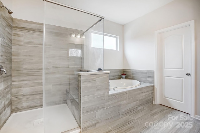 full bathroom with a garden tub and a shower stall