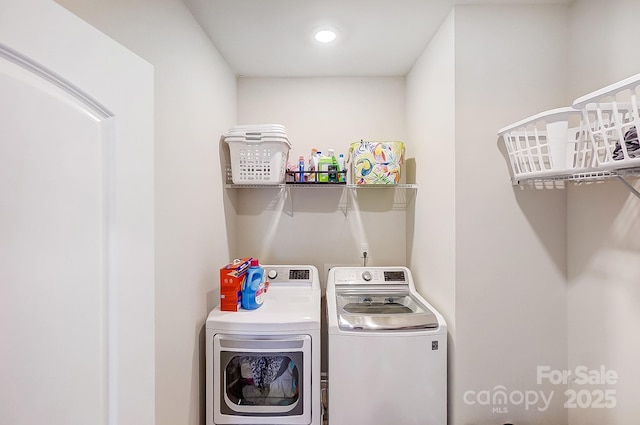 washroom featuring laundry area and washing machine and dryer