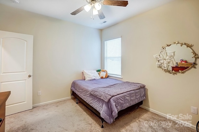 carpeted bedroom featuring a ceiling fan, baseboards, and visible vents