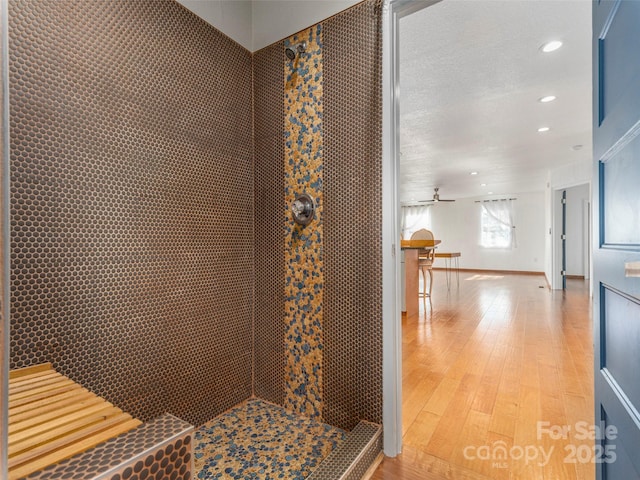 bathroom with hardwood / wood-style flooring and recessed lighting