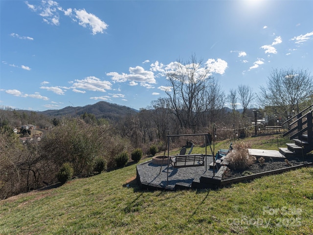 view of yard with an outdoor fire pit and a mountain view