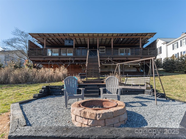 rear view of house featuring an outdoor fire pit, stairway, and a patio