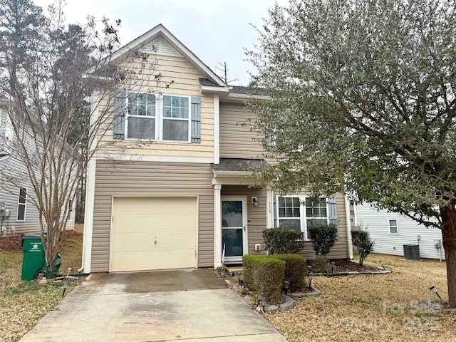 traditional-style home with an attached garage, concrete driveway, and central AC