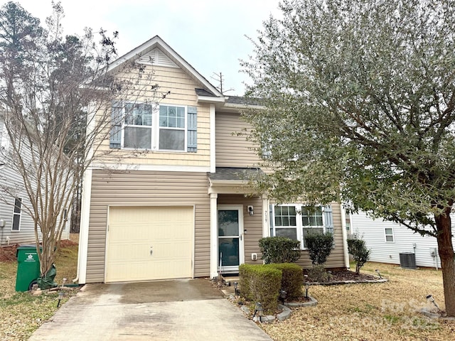 traditional-style house featuring driveway, an attached garage, and central air condition unit