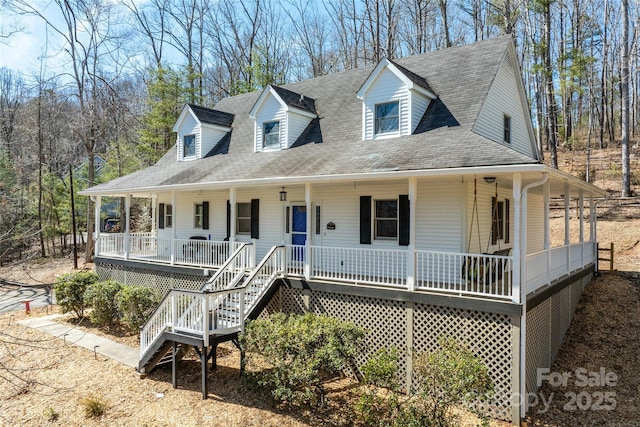 country-style home with a shingled roof and a porch