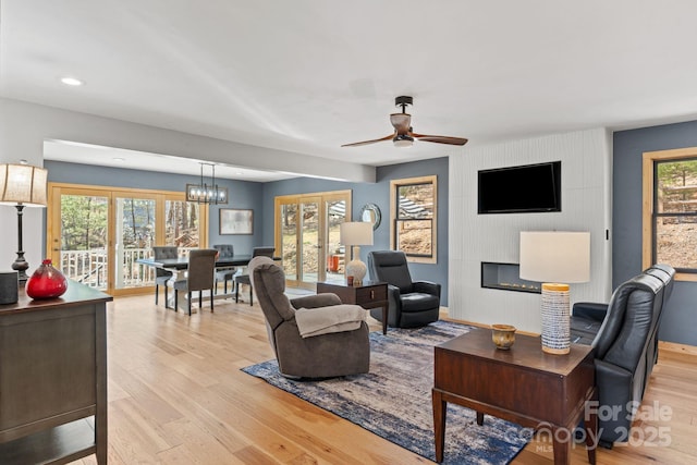 living area with french doors, plenty of natural light, and light wood-style flooring