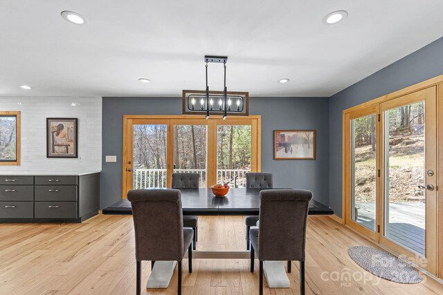 dining space with light wood finished floors and recessed lighting