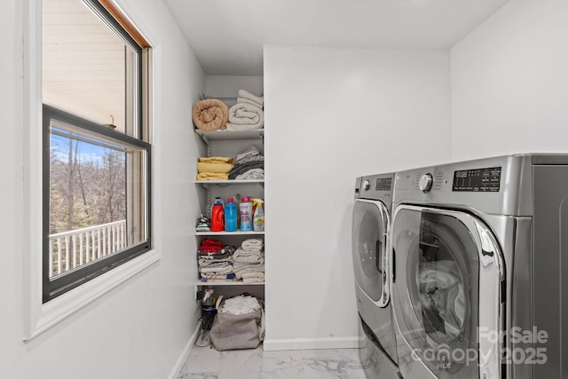 laundry area featuring laundry area, baseboards, marble finish floor, and washing machine and clothes dryer