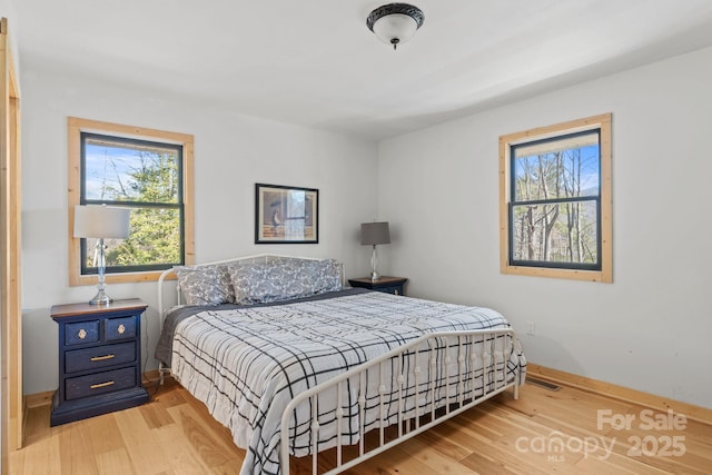 bedroom with wood finished floors and baseboards