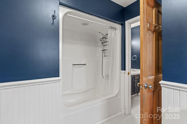 full bath featuring wainscoting