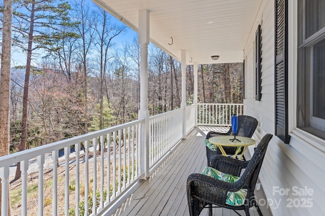 deck featuring a view of trees