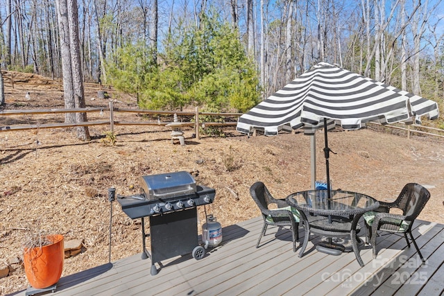 deck featuring fence, outdoor dining area, and area for grilling