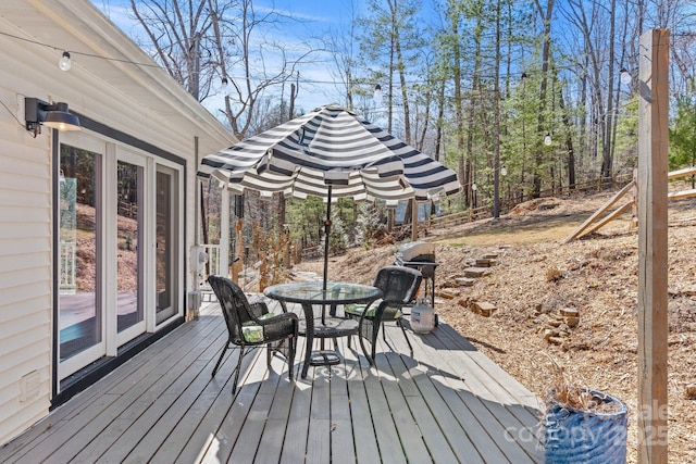 wooden deck featuring outdoor dining space