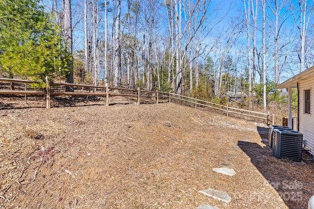 view of yard featuring cooling unit and fence