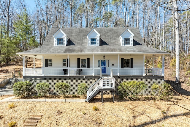 country-style home featuring a porch and stairway