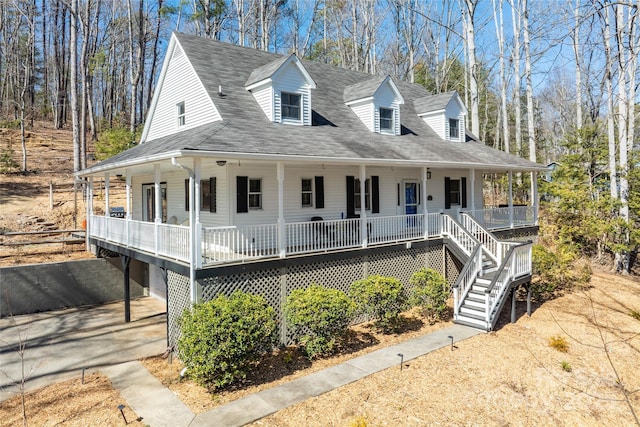 view of front facade featuring aphalt driveway, covered porch, roof with shingles, and stairway