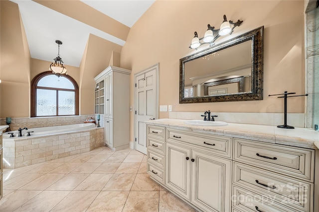 full bathroom featuring tile patterned flooring, a garden tub, and vanity