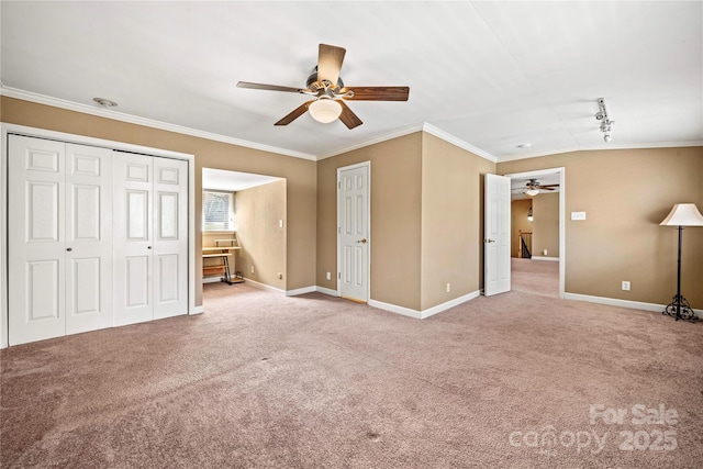 unfurnished bedroom with baseboards, ceiling fan, carpet, and crown molding