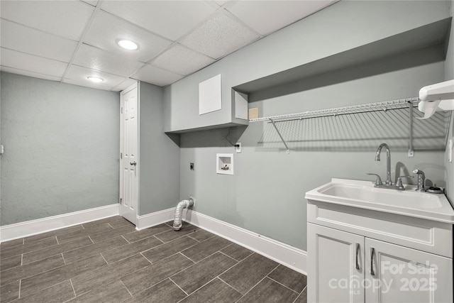 clothes washing area featuring wood finish floors, washer hookup, a sink, and hookup for an electric dryer