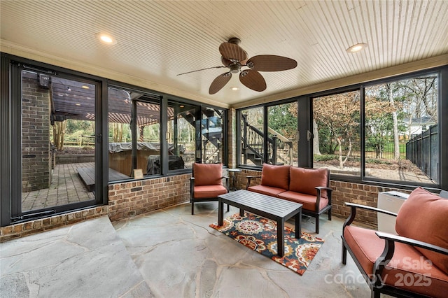 sunroom / solarium with ceiling fan and wood ceiling