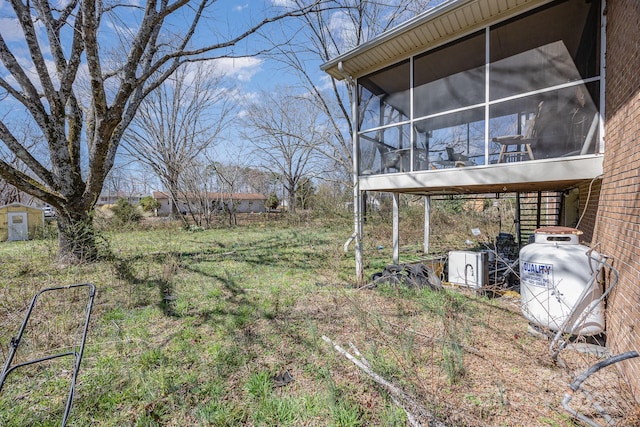 view of yard featuring stairway and a sunroom