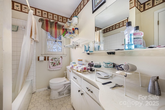 bathroom featuring toilet, shower / tub combo, and vanity